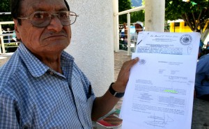 Don Avisaín Solís López exhibe documentos firmados por la CFE en los que se comprometió en 1985 pagar unas tierras afectadas con Chicoasén I y hasta la fecha no cumple. Foto: Isaín Mandujano/Chiapa PARALELO