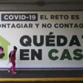 A woman walks past a sign that reads in Spanish " COVID=19. The challenge is no to get it and not spread it. Stay home," in Mexico City, Tuesday, March 31, 2020. Mexico's government has broadened its shutdown of "non essential activities," and prohibited gatherings of more than 50 people as a way to help slow down the spread of the new coronavirus. The one-month emergency measures will be in effect from March 30 to April 30. (AP Photo / Eduardo Verdugo)